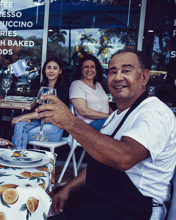 Maria and Toni in the outside dining area, enjoying a glass of wine.