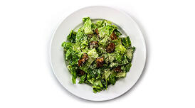 A simple Cesar salad with grated Parmesan and croutons