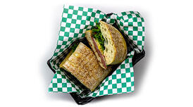 A halved toasted Seby in a basket